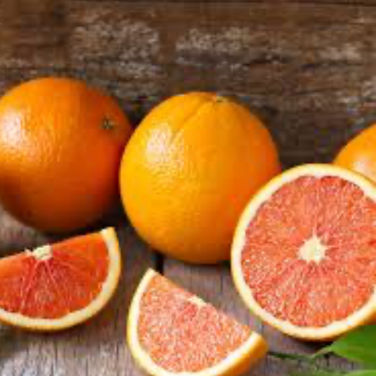 a collection of whole and cut up red navel oranges with a wooden background