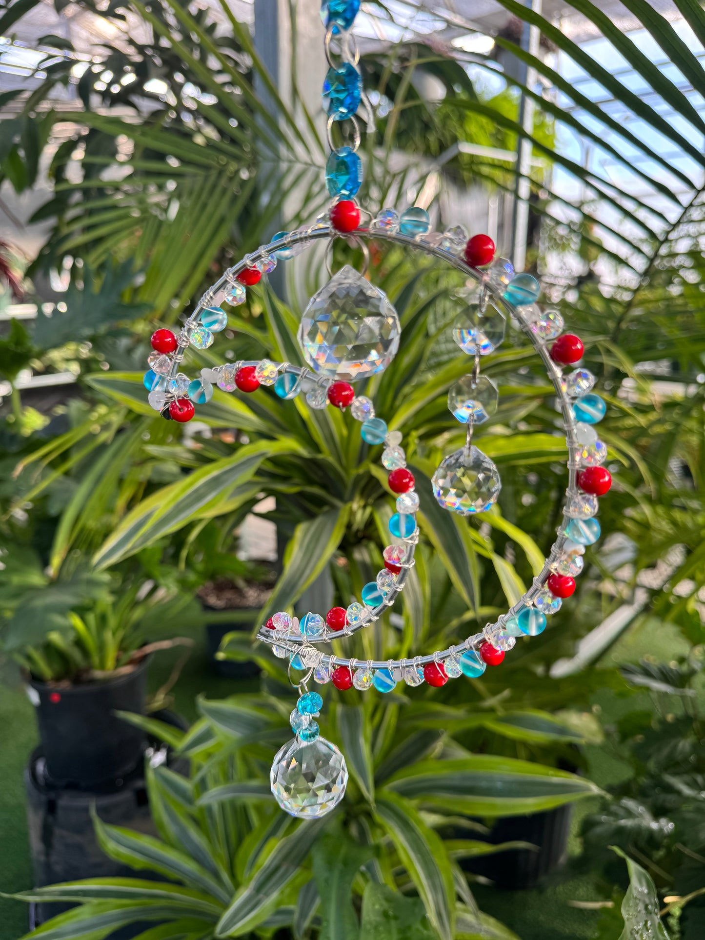 decorative moon shaped sun catcher with red white and blue beading