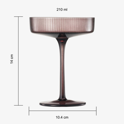 a brown coloured ribbed champagne glass against a plain white background