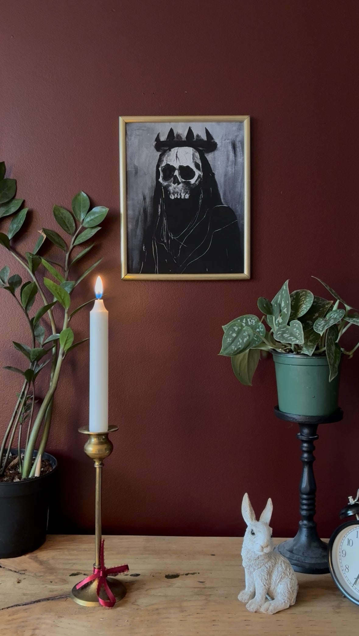 fantasy inspired art print of a skeleton with a black crown and grey background hung on a red wall