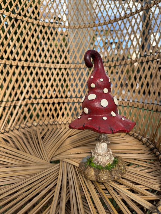 Decorative mushroom ornament with white spots on a woven surface