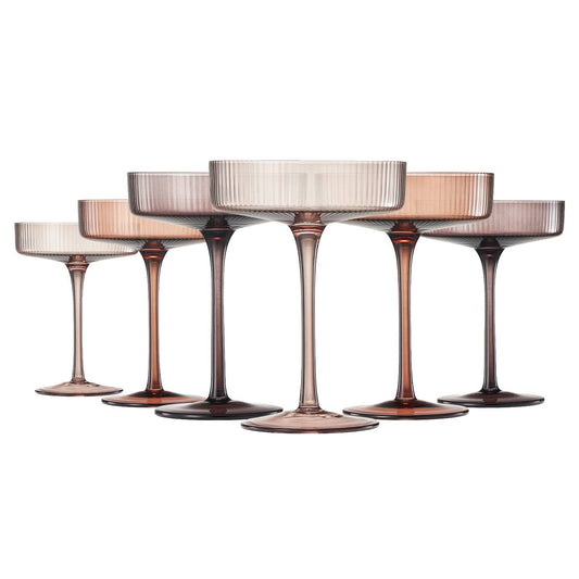 A set of five champagne coupe glasses with a ribbed design, featuring a vintage pink color at the rim, displayed against a white background.