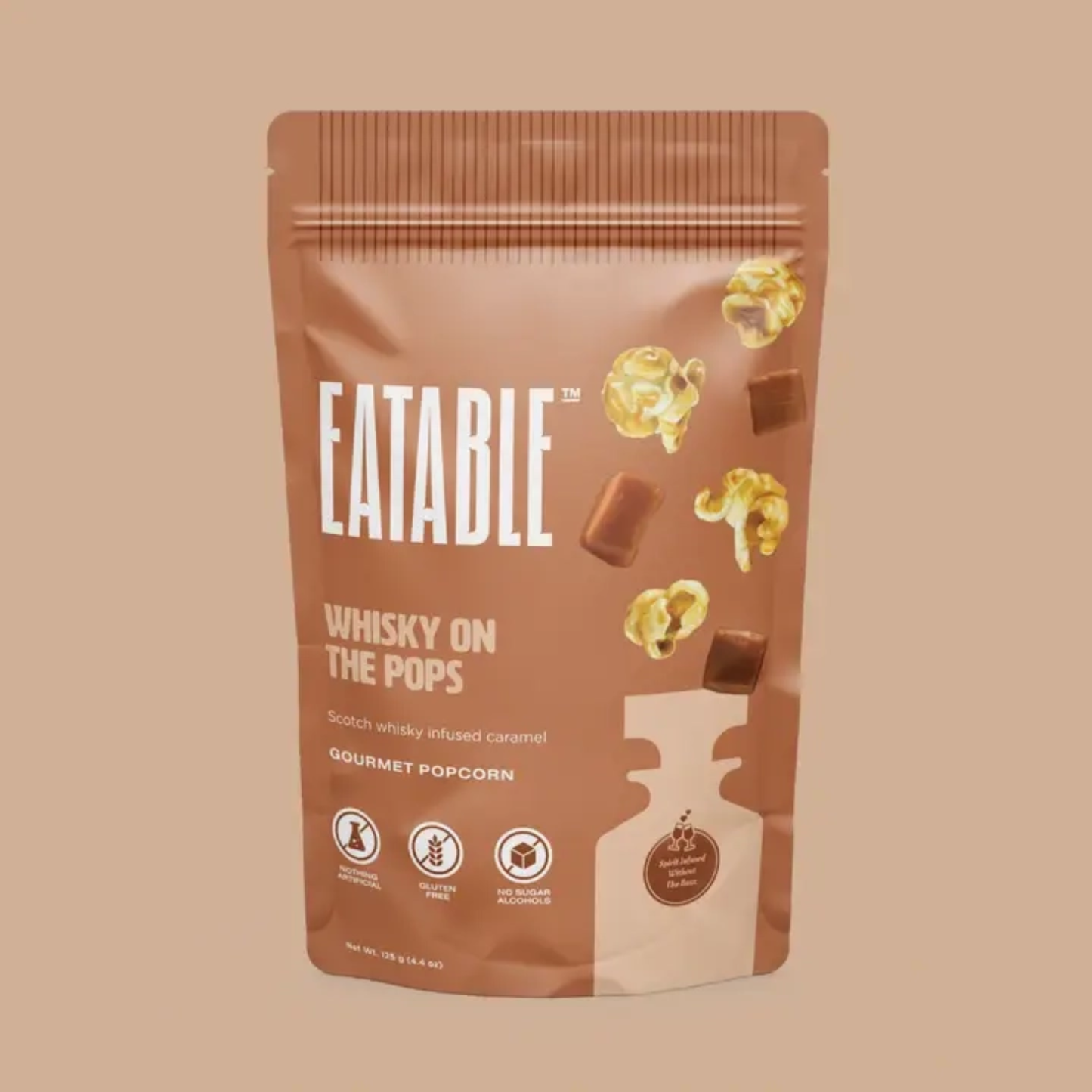 Eatable Whisky on the Pops gourmet popcorn packaging on a beige background