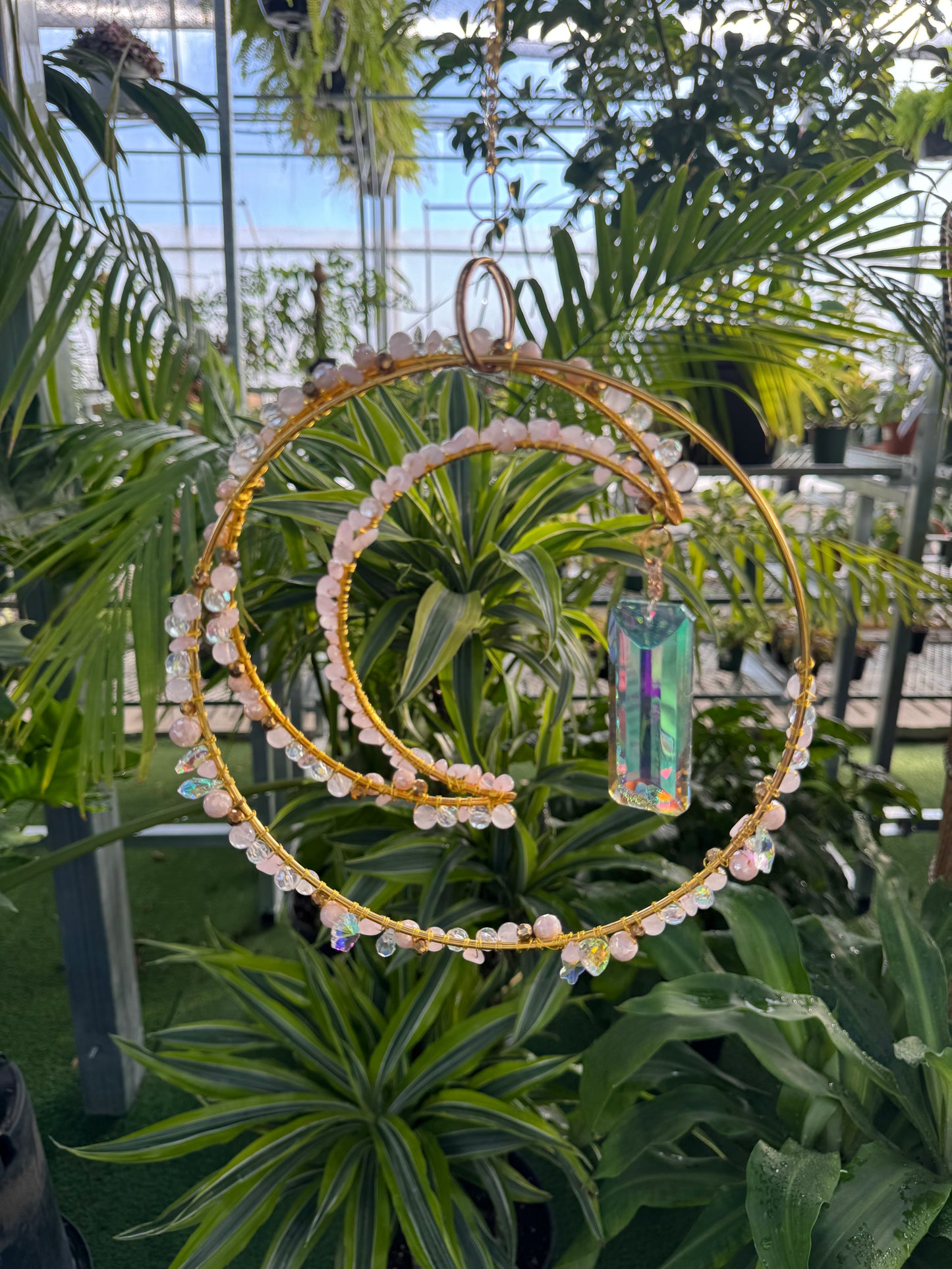 decorative moon and hoop sun catcher with white beads and a large crystal