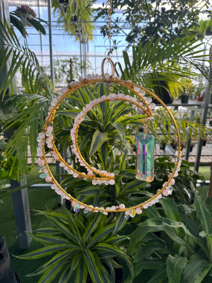 decorative moon and hoop sun catcher with white beads and a large crystal