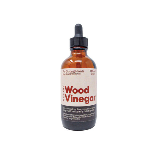 Bottle of wood vinegar with a dropper on a white background
