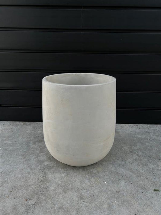 Round cement planter with a textured finish, placed against a black background.