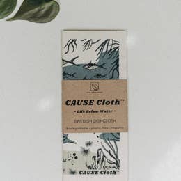 folded cloth with underwater and shark pattern wrapped with branding titled cause cloth