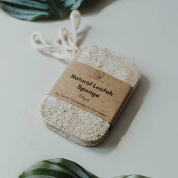A pack of three white natural loofah sponge.